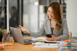 © Thitisak - Asian businesswoman working on documents at office