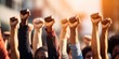© piai - Group of multi ethnic people raising their fists up in the air