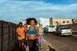 © Marko Geber - Young and diverse group of friends jogging and running together in the city