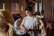 © Marko Geber - Young and diverse group of friends washing dishes after breakfast in their flatshare apartment