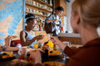 © Marko Geber - Young and diverse group of flatsharing roommates having breakfast together in their shared apartments kitchen