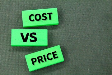 colored wood with the words cost vs price. the concept of calculation management or price calculation