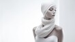 A mannequin with a white scarf wrapped around its head and neck on a white background. The scarf is loose and flowing and has a smooth texture. The mannequin has a gray square covering its face.