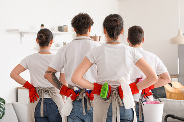 Poster - Young janitors with cleaning supplies in kitchen, back view