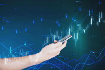 Wall Mural - Close up of businessman hand holding cellphone with glowing candlestick forex chart and index hologram on blurry background. Trade and stats concept. Double exposure.