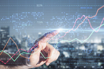 Poster - Close up of male hand pointing at creative business graph with index and grid on blurry city background. Stock market and financial statistics concept. Double exposure.