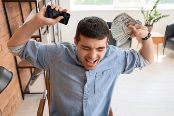 Wall Mural - Angry young man with money in office