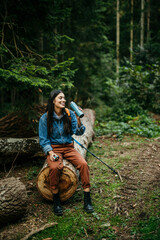 Wall Mural - Active young woman hydrating during an invigorating hike, absorbing the sights and sounds of the wilderness