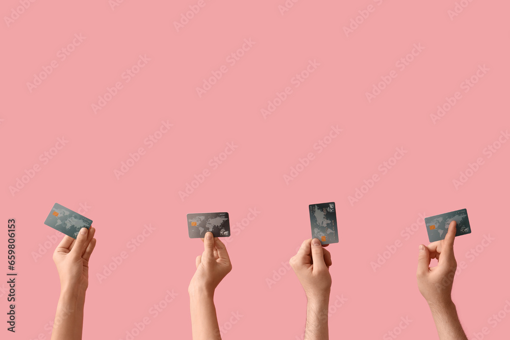Women with credit cards on pink background