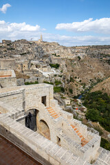 Wall Mural - View of the Sassi di Matera a historic district in the city of Matera, well-known for their ancient cave dwellings. Basilicata. Italy