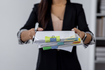 Wall Mural - Businesswoman hands working in Stacks of paper files for searching and checking unfinished document achieves on folders papers at busy work desk office
