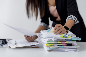 Wall Mural - Businesswoman hands working in Stacks of paper files for searching and checking unfinished document achieves on folders papers at busy work desk office
