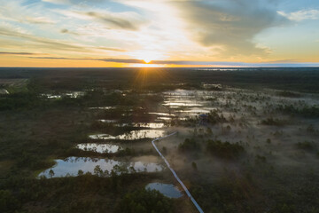 Nature of Estonia, sunrise on a swamp in summer. Fog over the lakes. View from a drone.