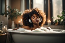 A Beautiful Sexy African American Woman With Her Eyes Closed Relaxes In A Bubble Bath And Listens To Music By Candlelight