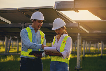 Electrical, instrument technician survey, checking, maintenance electric system at solar panel field in sunny day