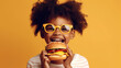 african american child eating hamburger 
