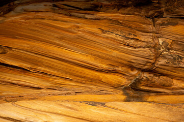 Wall Mural - Full frame of sandstone rock pattern, Rock formation, natural of sand stone on beach in Australia, line and curve of stone use for background