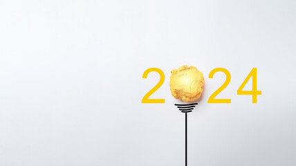 Poster - Yellow scrap paper ball for virtual lightbulb with 2024 on white background for creative thinking innovation and problem solving in new year concept.