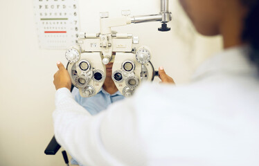 Wall Mural - Woman, eye exam and phoropter for optometrist with health check, lens or vision for wellness in clinic. Doctor, eyesight tools or machine for help with assessment, consultation or glasses in hospital