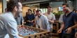 Candid laughter and high-fives exchanged over a foosball table, concept of Happy camaraderie