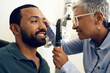 © N F/peopleimages.com - Patient, eye care and medical ophthalmoscope in clinic to check retina, ocular services and healthcare consultation. Optometrist, glaucoma analysis and testing eyesight of happy man with vision tools