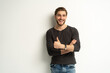 © opolja - Portrait of cheerful man in casual clothing smiling and showing thumbs up at camera isolated over white