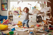 A playful hyperactive cute toddler misbehaving and making a mess in a kids room, throwing around things. Generative AI