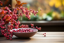 Empty Wooden Table The Background Of A Window With A Beautiful Autumn Foliage Background. Colorful Leaves, One Bowl Filled With Cranberries Vase With Yellow Mums, Ready For Product Montage, Mockup