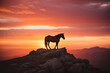 The sun sets behind a lone wild horse, perched atop a rocky mountain peak, its silhouette a striking contrast against the vibrant orange and pink sky, special concept for international horse day.