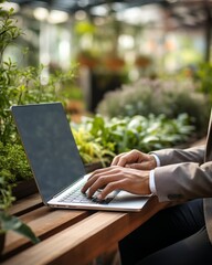 Wall Mural - hand closeup businessman working online using laptop business working concept with background of garden park