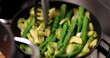 Cooking legumes on pan, stirring asparagus green vegetables