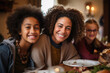 Single parent family of a happy mother eating with her two daughters in a restaurant