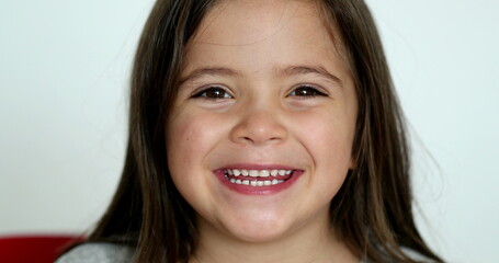 Wall Mural - Happy little girl child face close-up smiling