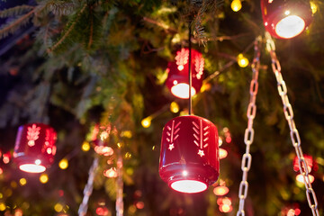 Retro street lantern, lamp with yellow glowing light on building wall with snow, winter decoration in cold weather.