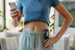 © Halfpoint - Close up of diabetic woman with insulin pump. Young woman with diabetes at home.