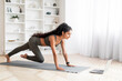 © Prostock-studio - Active Millennial Indian Woman Undertaking Digital Exercise Session, Home Interior