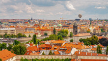 Prague, Czech Republic. Panoramic Over Vltava River With Big Tour Boats, Famous Charles Bridge, Touristic Air Balloon, Tourists At Walking Embankment In Historical Downtown Of City