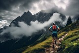 Fototapeta  - An ultra trail runner trains in a beautiful mountain, with an incredible backdrop of snowy peaks. Sports concept, trail running, hiking.