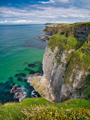 high coastal cliffs on the antrim coast, near giant's causeway, northern ireland. the ruins of dunlu