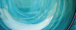 Closeup of a teal Cuenca ceramic with a glossy finish. The glaze appears to have a watercolorlike quality, with soft and blending shades of blue and green.