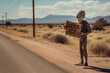 Alien hitch-hiking by the side of the road and holding a sign that says 