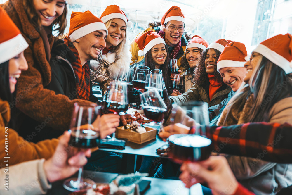 Happy people wearing santa claus hat having Christmas dinner party ...