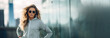 An image of a confident woman in a sports suit against a city background. banner, place for text