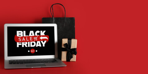 Canvas Print - Laptop, shopping bag and gift on red background with space for text. Black Friday sale