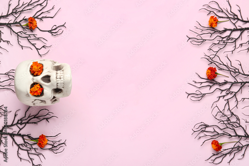 Human skull with marigold flowers and tree branches on pink background
