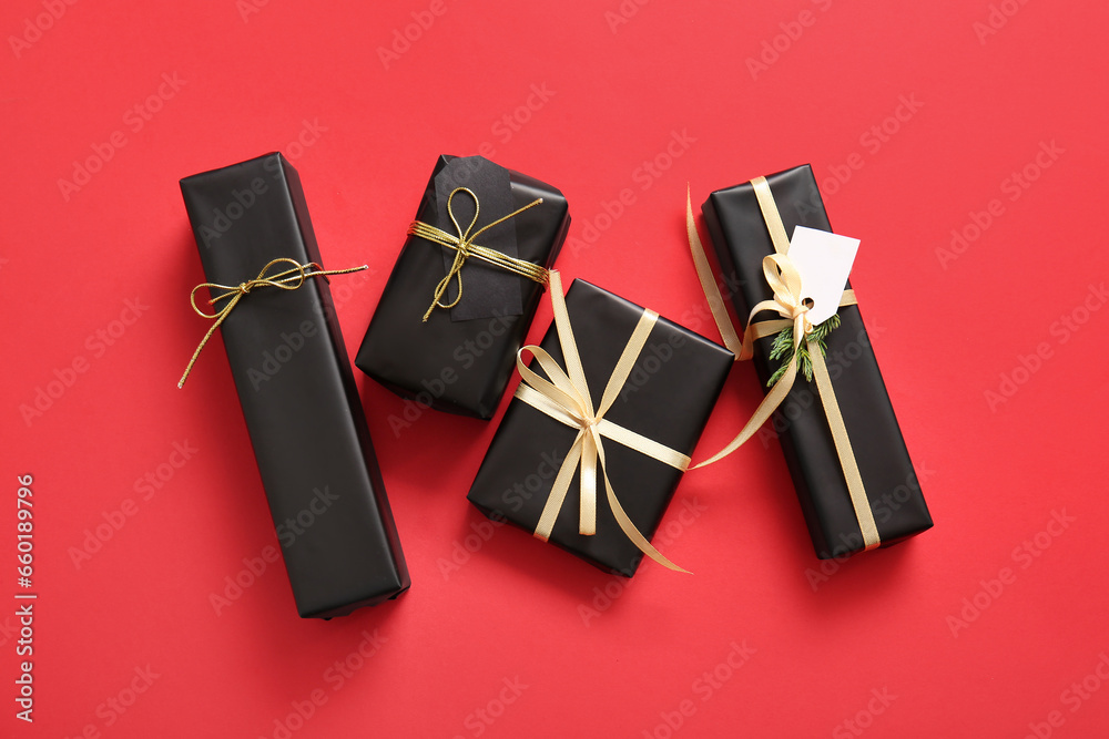 Black Christmas gift boxes on red background