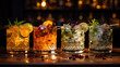 Four delicious cocktails with lots of ice are lined up next to each other in a rustic bar