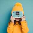 A child's playful exploration of photography as they hold a vintage camera, embracing their creative spirit and curiosity
