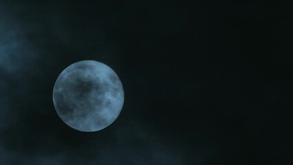 Wall Mural - clouds passing by the hollow bright moon. clouds on a full moon. close-up. blank space for text. mys