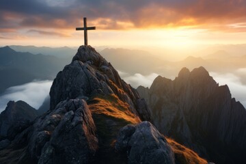 A cross standing on top of the mountain at Sunrise, religious concept background.
